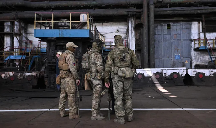 Russian servicemen guarding in a metal rolling shop at the Alchevsk Iron and Steel Works in Alchevsk, amid the ongoing Russian military action in Ukraine on June 11, 2022.