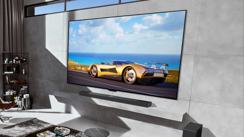 LG M4 OLED TV on grey wall with car on screen lifestyle image