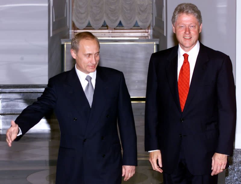 FILE PHOTO: Russian President Vladimir Putin (L) gestures to invite U.S. President Bill Clinton