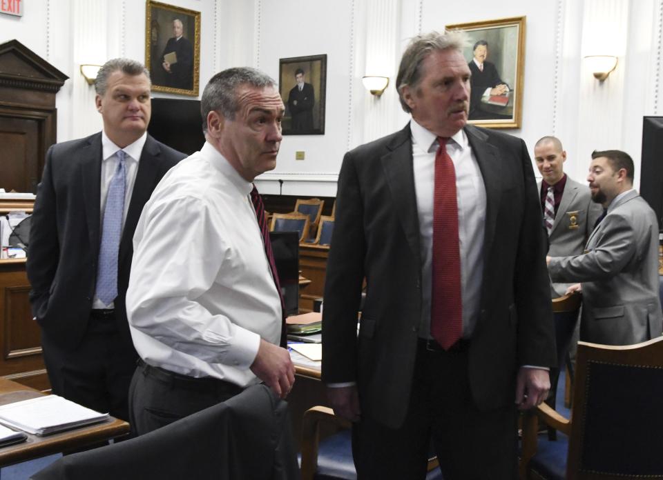 Defense attorney Mark Richards, center and potential defense witnesses Todd Wilson, left and Steve Spignola, talk before the start of Kyle Rittenhouse's trial at the Kenosha County Courthouse in Kenosha, Wis., on Wednesday, Nov. 3, 2021. Rittenhouse is accused of killing two people and wounding a third during a protest over police brutality in Kenosha, last year. (Mark Hertzberg /Pool Photo via AP)