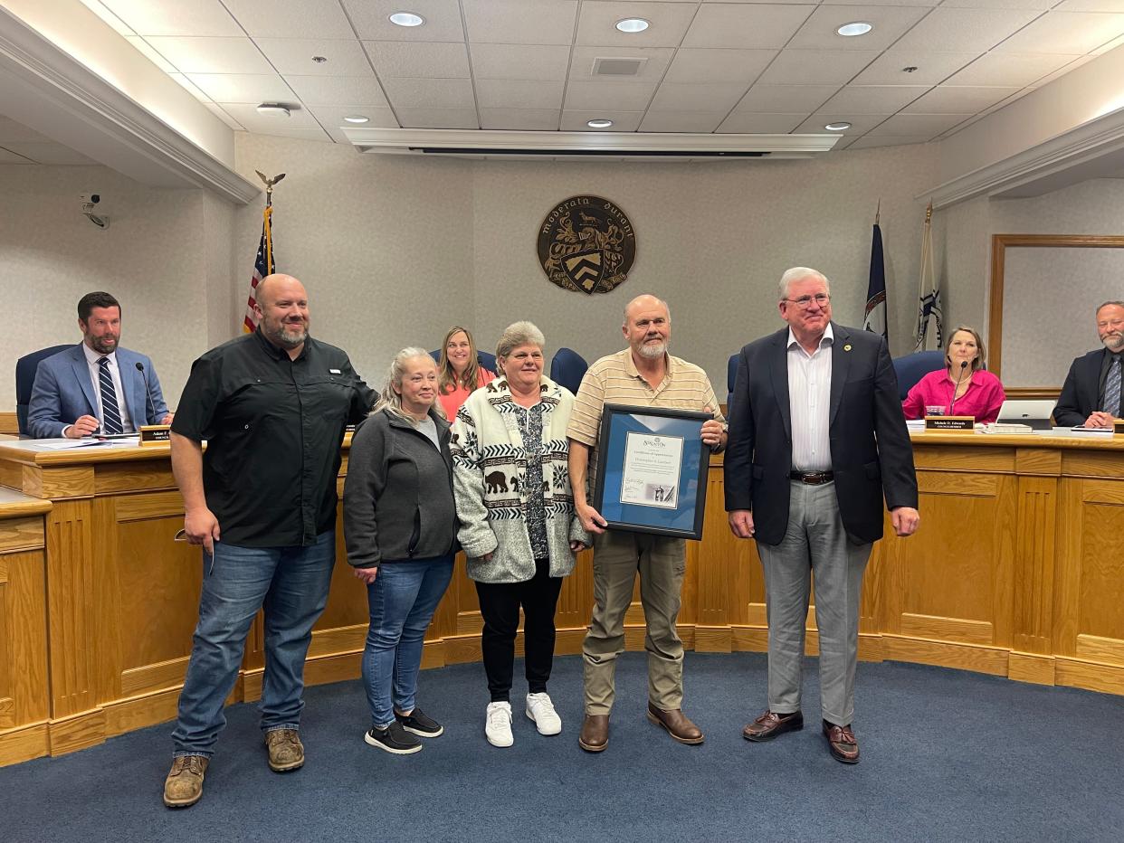 Christopher Lambert (second from right) was honored for his years of service, while Christopher Lambert Jr. (left) was recently promoted in Staunton.