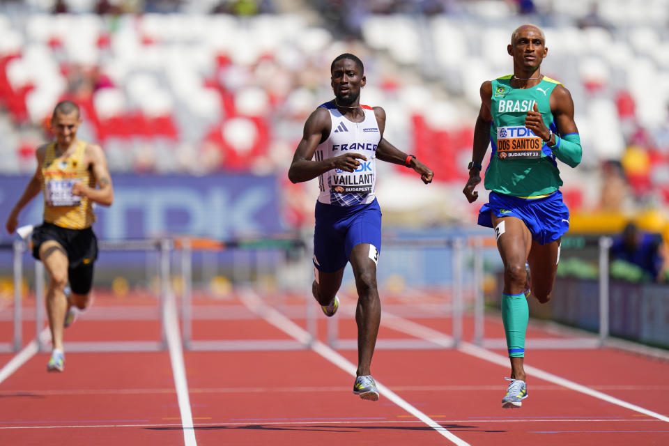 Ludvy Vaillant, of France and Alison Dos Santos, of Brazil finish a men's 400-meters hurdles heat during the World Athletics Championships in Budapest, Hungary, Sunday, Aug. 20, 2023. (AP Photo/Petr David Josek)