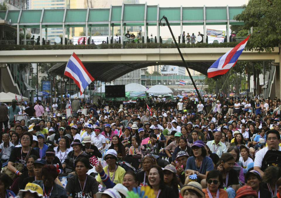 In this photo taken Jan. 15, 2014, anti-government protesters listen to a speech during a rally led by former deputy prime minister Suthep Thaugsuban at Ratchabrasong intersection in Bangkok, Thailand. Four years ago Suthep ordered a crackdown that saw the army rip through anti-government protesters’ tire-and-bamboo-barricaded encampments and fire M-16s into crowds of fleeing protesters. Today, he is leading a protest movement that has itself blocked roads and broken into government offices - an extraordinary role reversal that underscores not only the cyclical nature of Thai politics, but the total lack of progress toward bridging a political divide that has plagued the country for nearly a decade. Among the places his supporters occupy is the place the Red Shirts made their last stand four years ago: Ratchaprasong, the country’s glitziest intersection, where just like the Red Shirts, protesters are camping in the middle of the road, in front of a huge stage complete with speakers and a giant video screen. (AP Photo/Sakchai Lalit)