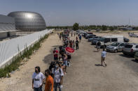 People queue to be vaccinated against COVID-19 at the Isabel Zendal Hospital in Madrid, Spain, Tuesday, July 20, 2021. Spain is trying to stamp out a new wave of COVID-19 among its youth thanks to a robust vaccination program that is widely supported. Spain like the rest of the European Union got off to a slow start to compared to the United States and Britain when the first vaccines were released. But it has quickly made up ground once deliveries by drug makers started flowing. (AP Photo/Olmo Calvo)