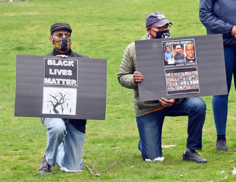 Paul Glass (left) and Charles Evans of Falmouth kneel during a 2021 demonstration of Black Lives Matter in Falmouth.