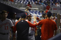 Washington Nationals left fielder Kyle Schwarber (12) celebrates a solo home run with teammates in the dugout during the first inning of a baseball game on Thursday, June 24, 2021, in Miami. (AP Photo/Mary Holt)