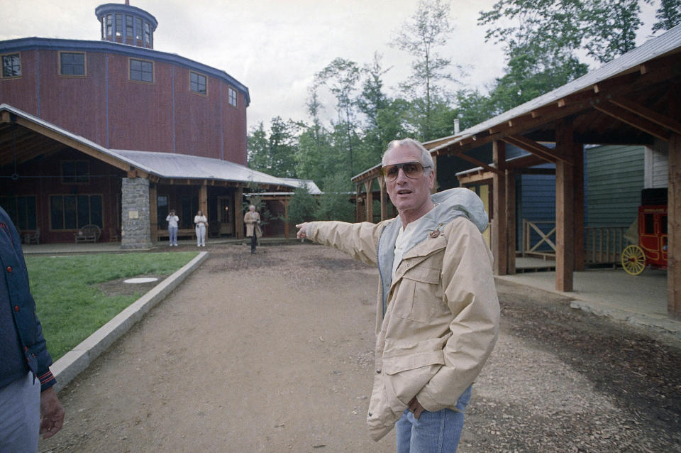 FILE - In this Thursday, June 9, 1988 file photo, Actor Paul Newman gestures as he arrives at "The Hole in the Wall" camp in Ashford, Conn. Newman is the camp founder and $7 million of profits from his "Newman's Own" Food Products, Inc. was contributed to help finance the camp. A fire on Friday evening, Feb. 12, 2021 destroyed four buildings at Paul Newman’s Hole in the Wall Gang Camp for seriously ill children in Connecticut. (AP Photo/Bob Child. File)