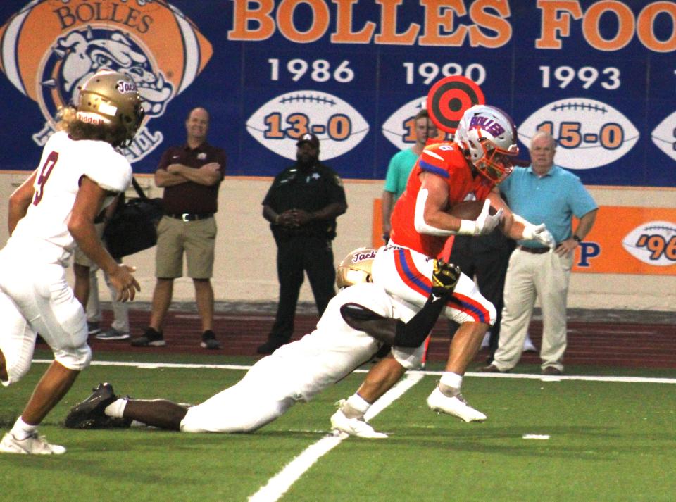 Bolles running back Kade Frew (8) rushes upfield as St. Augustine safety Tyshawn Campbell (1) tries to tackle him during a high school football game on September 10, 2021. [Clayton Freeman/Florida Times-Union]