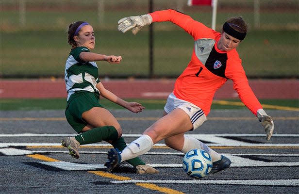 (2/29/20)Manteca's Cameron Silva, shoots the ball past Christian Brothers goalkeeper Lillian Smith to score during the Sac-Joaquin Section Division III girls soccer championship played at Liberty Ranch High School in Galt. [CLIFFORD OTO/THE RECORD]