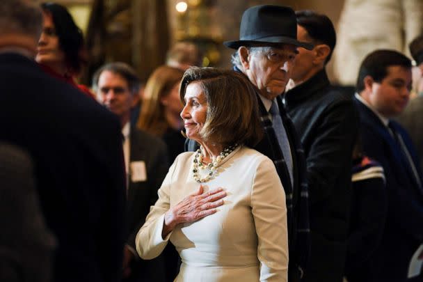 PHOTO: House Speaker Nancy Pelosi (D-CA) watches the color guard arrive before a portrait of her is unveiled at Statuary Hall in the U.S. Capitol, U.S., Dec. 14, 2022. (Mary F. Calvert/Reuters)
