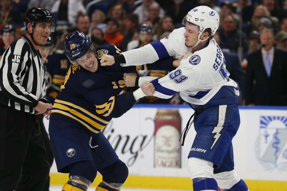 Buffalo Sabres defenseman Jake McCabe (19) and Tampa Bay Lightning defenseman Mikhail Sergachev (98) fight during the second period of an NHL hockey game Tuesday, Dec. 31, 2019, in Buffalo, N.Y. (AP Photo/Jeffrey T. Barnes)