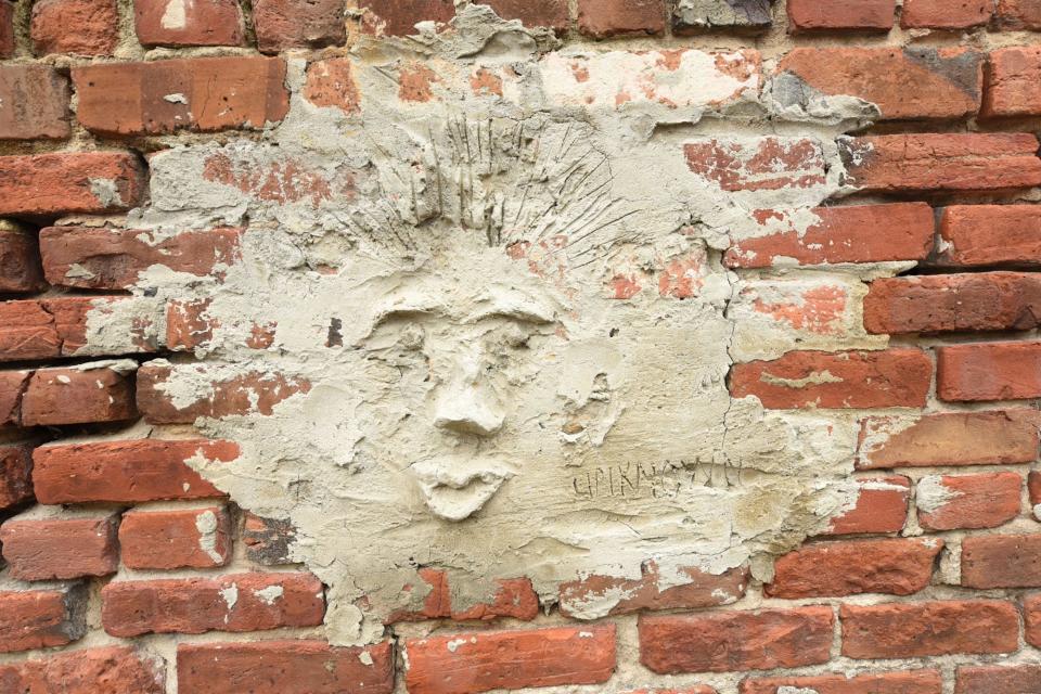 This rough-hewn mortar face was likely done on a whim, but it's been on this alley wall since at least the early 1990s, when the building was home to a gay nightclub called Mickey Ratz.