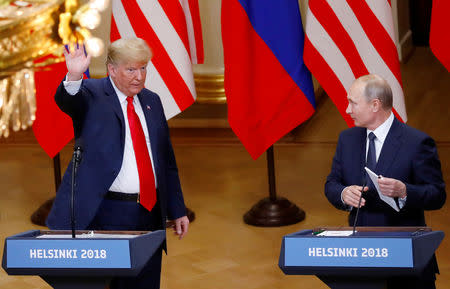 FILE PHOTO: U.S. President Donald Trump and Russian President Vladimir Putin react at the end of the joint news conference after their meeting in Helsinki, Finland, July 16, 2018. REUTERS/Leonhard Foeger/File Photo