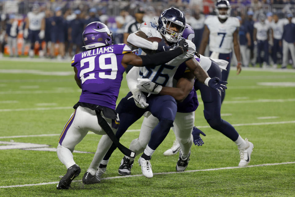 Minnesota Vikings cornerback Joejuan Williams (29) and others combine to stop Tennessee Titans running back Julius Chestnut (36) after a short gain in the second half of a preseason NFL football game, Saturday, Aug. 19, 2023, in Minneapolis. (AP Photo/Bruce Kluckhohn)