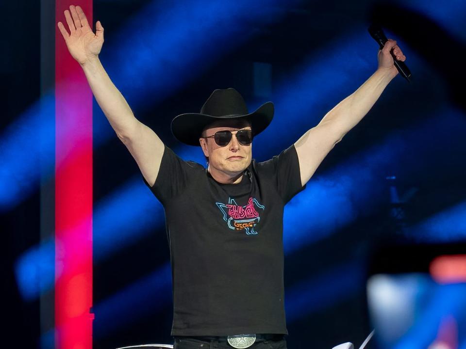 Elon Musk in a cowboy hat and sunglasses in a celebratory pose