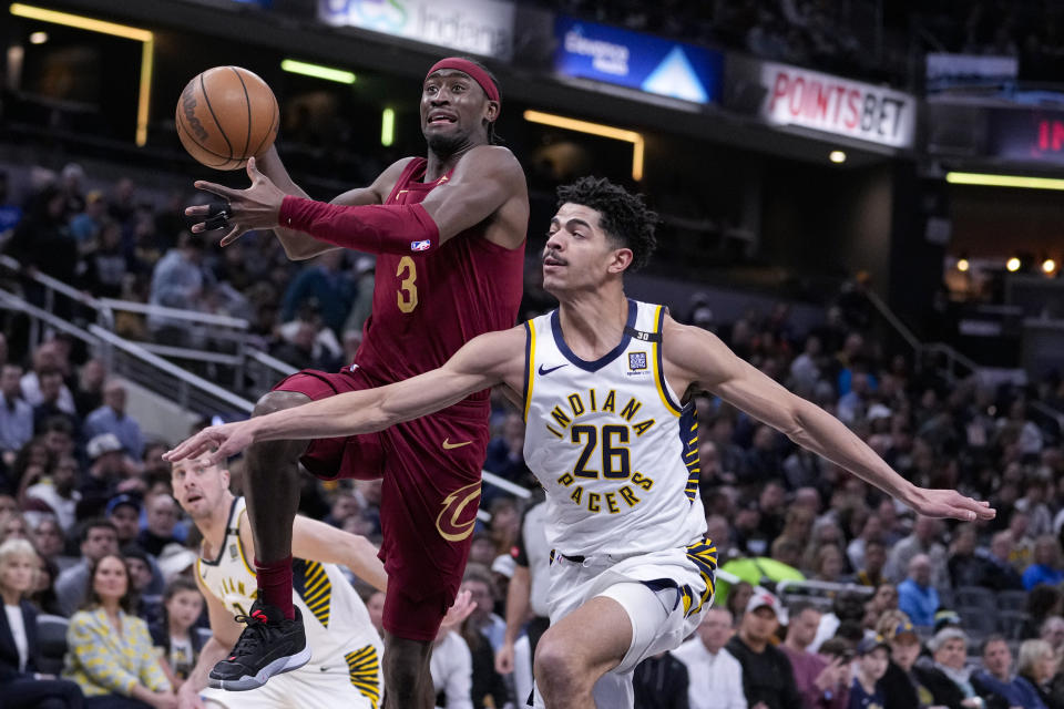 Cleveland Cavaliers guard Caris LeVert (3) shoots over Indiana Pacers guard Ben Sheppard (26) during the first half of an NBA basketball game in Indianapolis, Monday, March 18, 2024. (AP Photo/Michael Conroy)
