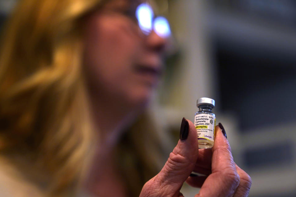 Becky Hormuth holds a vial of testosterone Wednesday, Sept. 20, 2023, in Wentzville, Mo. Hormuth has been carefully dosing the drug given to her 16-year-old because she is fearful of losing care for her son who came out as transgender about four years ago as some states have worked to ban gender-affirming for minors. (AP Photo/Jeff Roberson)