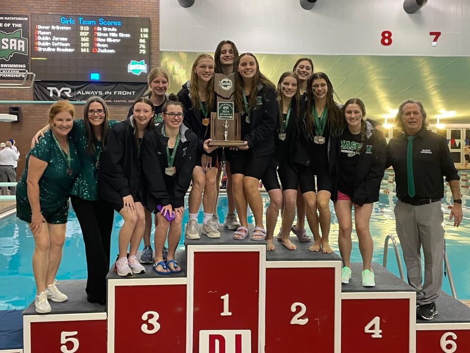 The Mason Lady Comets celebrate with their second-place trophy after scoring 207 points at the 2024 OHSAA state swimming and diving championships in Canton, Ohio.