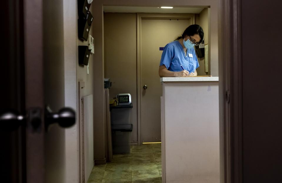 A female physician fills in patients charts after administering medication abortions.