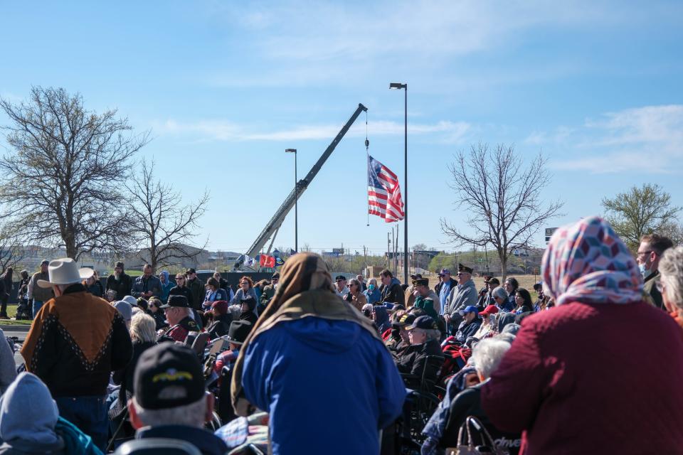 The crowd stands to observe the flag at the opening ceremony for the Vietnam Traveling Memorial Wall Wednesday at the Ussery-Roan Texas State Veterans Home in Amarillo.