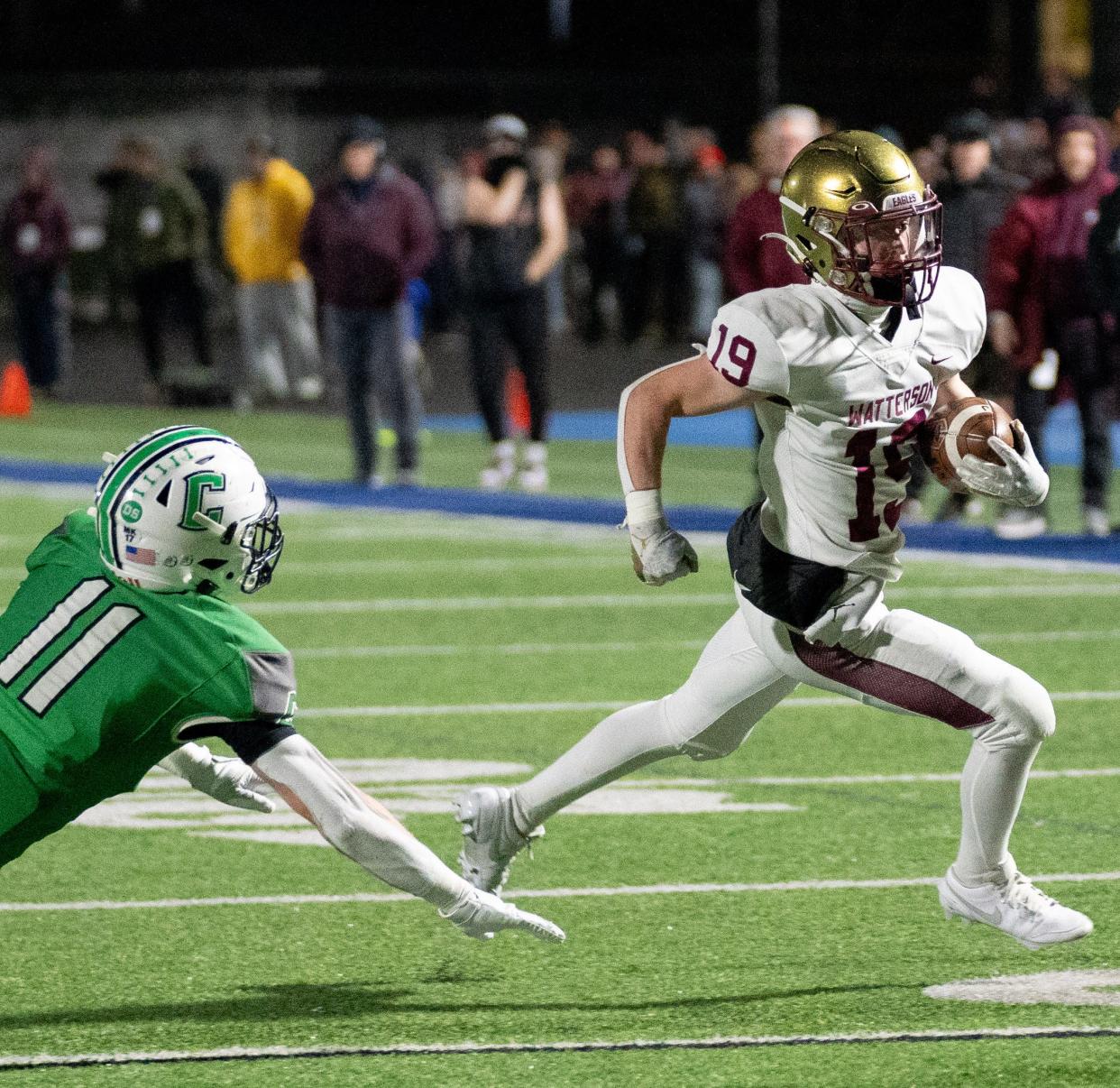 Watterson's Cal Mangini (19) runs past Celina's Jon Lutz’s (11) during the state semifinal.