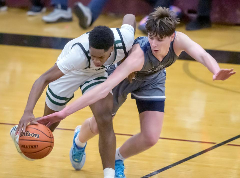 Peoria Notre Dame's Eoin Dillon, right, tries to knock the ball away from Richwoods' Jared Jackson in the second half of the Class 3A Boys Basketball Peoria Regional semifinals Wednesday, Feb. 22, 2023 at Peoria High School. The Knights defeated the Irish 51-40.