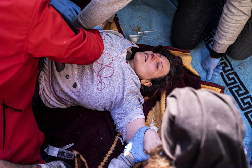 Rescue workers and medics pull out a person from a collapsed building in Antakya, Turkey, Wednesday, Feb. 15, 2023. More than 35,000 people have died in Turkey as a result of last week's earthquake, making it the deadliest such disaster since the country's founding 100 years ago. (Ugur Yildirim/DIA via AP)