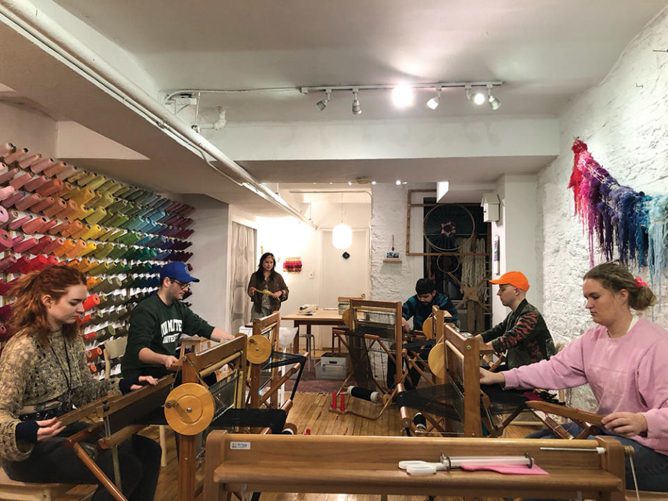 Students at NYU/Tisch Costume Studio III class weaving at Loop of the Loom