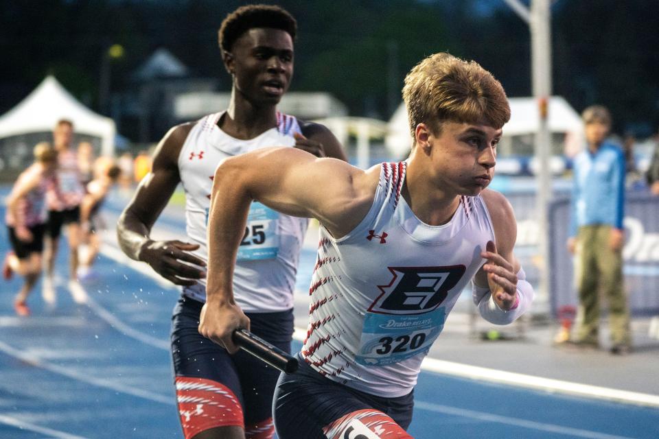 Ballard's Jakson Fleischmann runs the 4x400 meter relay after taking the baton from Jameson Witt during the Drake Relays on Saturday in Des Moines.