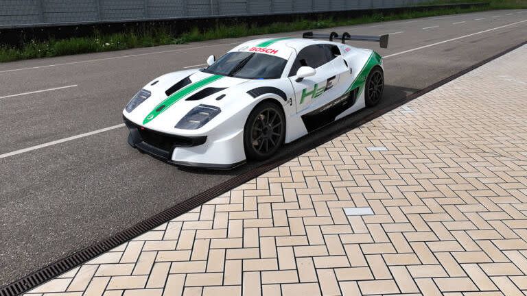 a white and green race car on a road