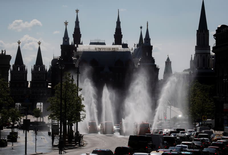 Vehicles spray disinfectant while sanitizing a road amid the outbreak of the coronavirus disease in Moscow