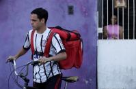Erik Thiago leaves his home before going to work, in Sao Paulo