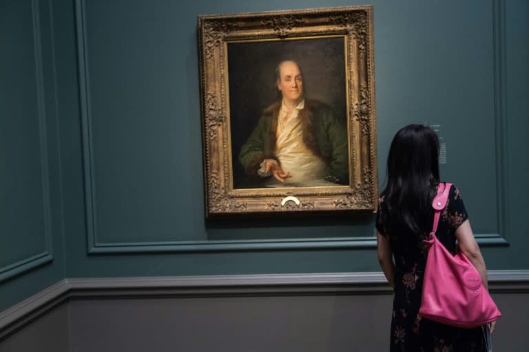 A visitor looks at "Portrait of Benjamin Franklin" (1778 or 1779), a friend of painter Anne Rosalie Bocquet Filleul