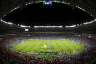 Ivory Coast and Japan players gather on the pitch before their 2014 World Cup Group C soccer match at the Pernambuco arena in Recife June 14, 2014. Picture taken with wide angle lens. REUTERS/Ruben Sprich