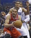 Chicago Bulls' Joakim Noah, front, looks to go up for a shot off a rebound in front of Orlando Magic's Tobias Harris during the first half of an NBA basketball game in Orlando, Fla., Wednesday, Jan. 15, 2014. (AP Photo/John Raoux)