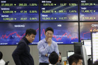 Currency traders work at the foreign exchange dealing room of the KEB Hana Bank headquarters in Seoul, South Korea, Wednesday, Dec. 4, 2019. Asian stock markets followed Wall Street lower after President Donald Trump cast doubt over the potential for a trade deal with China this year. (AP Photo/Ahn Young-joon)