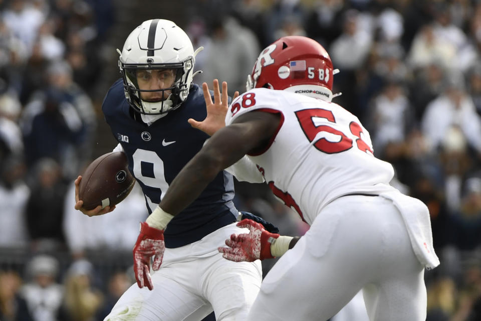 Penn State quarterback Christian Veilleux (9) looks to fend off Rutgers linebacker Mohamed Toure (58) during an NCAA college football game in State College, Pa., Saturday, Nov. 20, 2021. Penn State shut out Rutgers 28-0. (AP Photo/Barry Reeger)