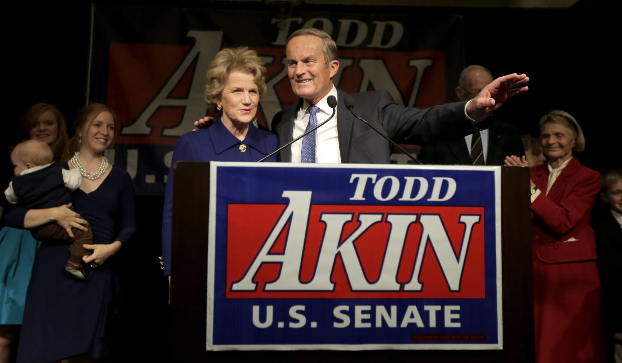 FILE - In this Nov. 6, 2012, file photo, U.S. Senate candidate, Rep. Todd Akin, R-Mo., and his wife Lulli acknowledge supporters before Akin makes his concession speech to U.S. Sen. Claire McCaskill, D-Mo. in Chesterfield, Mo. Akin, whose comment that women's bodies have a way of avoiding pregnancies in cases of "legitimate rape" sunk his bid for the U.S. Senate and became a cautionary tale for other GOP candidates, has died. He was 74. (AP Photo/Charlie Riedel, File)