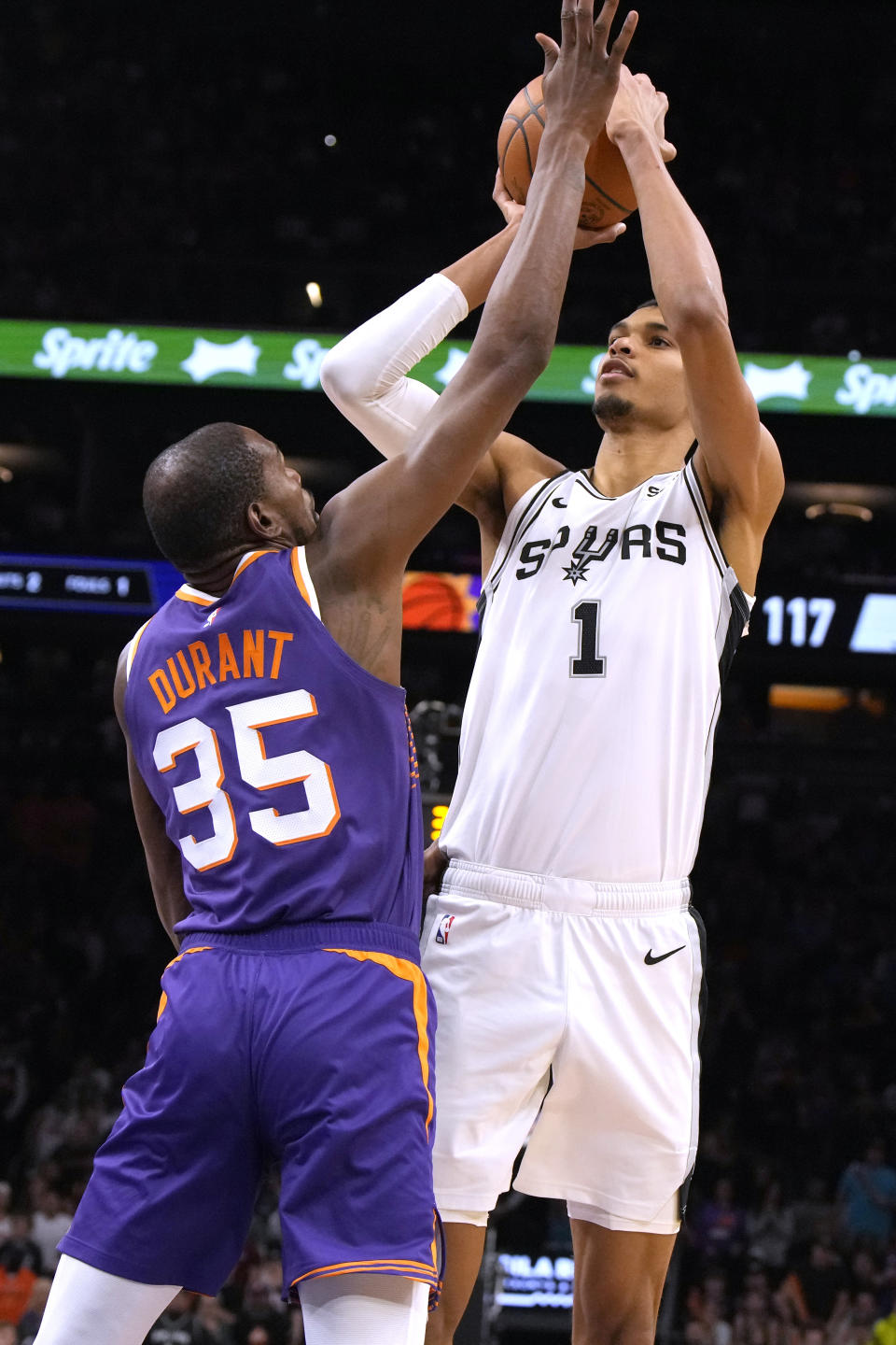 San Antonio Spurs center Victor Wembanyama (1) shoots over Phoenix Suns forward Kevin Durant during the second half of an NBA basketball game Thursday, Nov 2, 2023, in Phoenix. (AP Photo/Rick Scuteri)