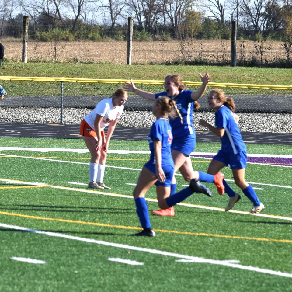 Aveona Yoder reacts after scoring the game-winning goal to send West Holmes to the state tournament, as Mariettta's Livi Rinard doubles over in anguish.