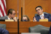 Texas state Rep. Jarred Shaffer, left, Rep. Donna Howard, center, and Rep. Chris Paddie, right, visit as the Committees on State Affairs and Energy Resources prepares to hold a joint public hearing to consider the factors that led to statewide electrical blackouts, Thursday, Feb. 25, 2021, in Austin, Texas. The hearings were the first in Texas since a blackout that was one of the worst in U.S. history, leaving more than 4 million customers without power and heat in subfreezing temperatures. (AP Photo/Eric Gay)