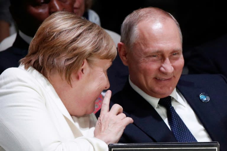 Some world leaders, such as Russian President Vladimir Putin, seen here with German Chancellor Angela Merkel, attended the Forum's opening session but left afterwards