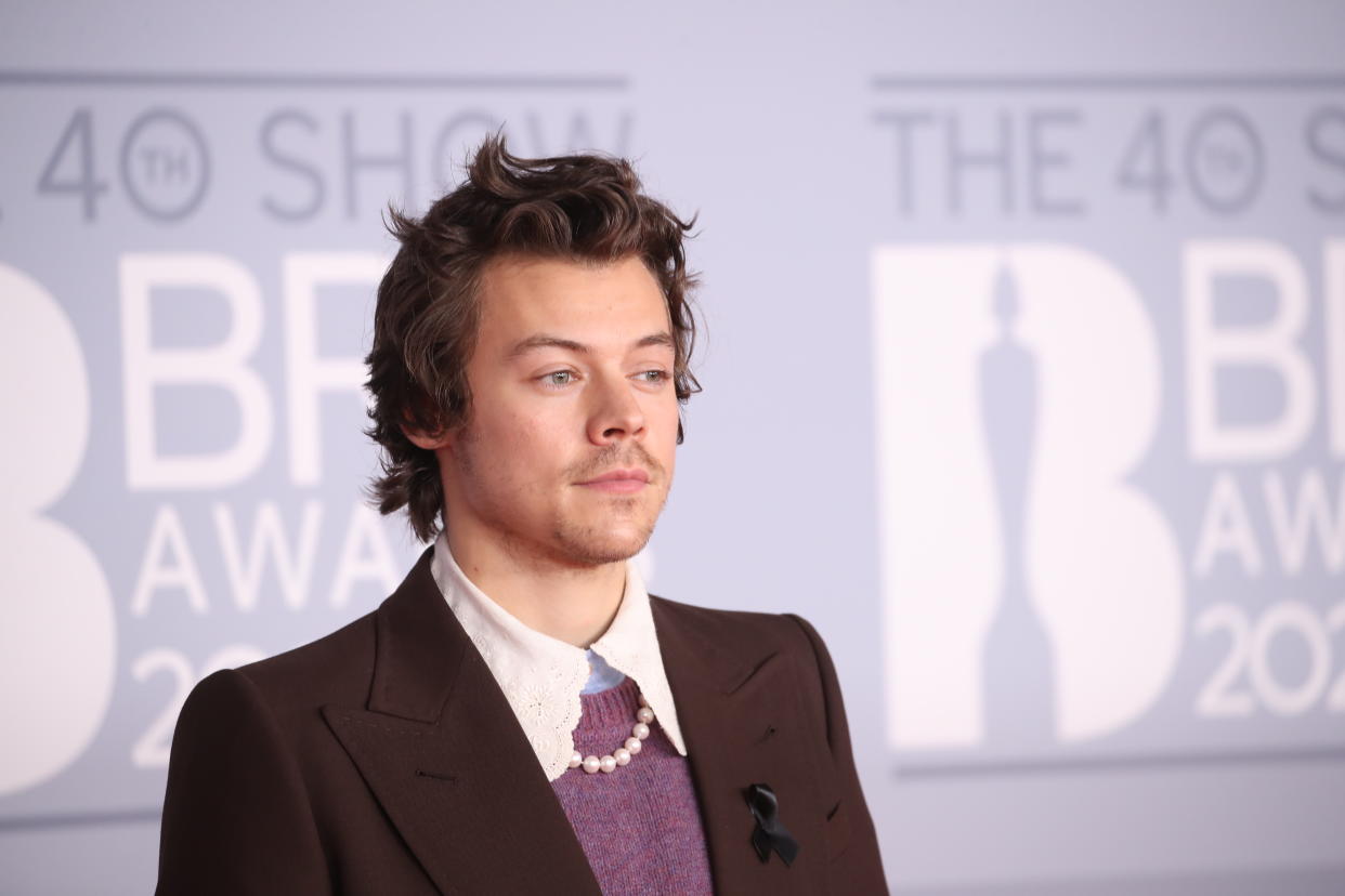 Harry Styles arrives on the Brit Awards red carpet. 