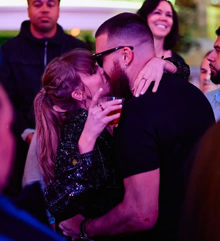 <p>Mike Kirschbaum</p> Taylor Swift and Travis Kelce kiss at XS Nightclub.