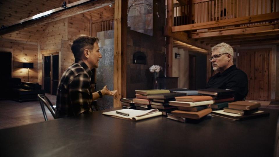 Director Bryan Fogel with Dr. Grigory Rodchenkov. Some of the chemist’s diaries sit on the table. - Credit: Orwell Films