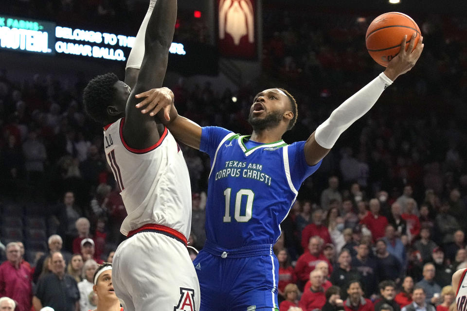 Texas A&M Corpus Christi forward Isaac Mushila (10) shoots on Arizona center Oumar Ballo during the first half of an NCAA college basketball game, Tuesday, Dec. 13, 2022, in Tucson, Ariz. (AP Photo/Rick Scuteri)