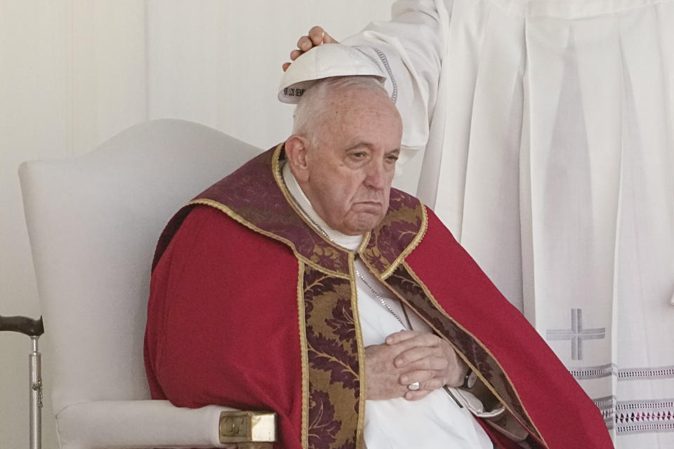 An aide removes Pope Francis' skull cap during a Mass at the Expo Grounds in Nur-Sultan, Kazakhstan, Wednesday, Sept. 14, 2022. (AP Photo/Alexander Zemlianichenko)