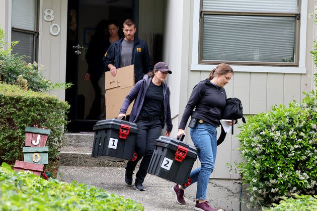 FBI agents carry boxes out of Mayor Sheng Thao's home Thursday in Oakland, California.