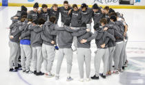 Players from the Slovakian team gather at center ice after the IIHF junior world hockey championship was cancelled in Red Deer, Alberta on Wednesday, Dec. 29, 2021. The remainder of the world junior hockey championship in Canada has been canceled over fears of a COVID-19 outbreak. The International Ice Hockey Federation made the announcement Wednesday on the recommendation of the organization’s medical officials. (Jeff McIntosh/The Canadian Press via AP)