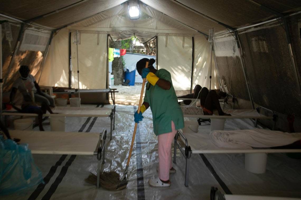 A hospital worker cleans inside a tent where people suffering cholera symptoms are treated at a clinic run by Doctors Without Borders in Port-au-Prince, Haiti, Friday, Oct. 7, 2022.